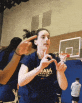 a woman wearing a blue shirt that says dana basketball
