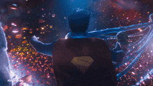 a man in a superman costume holds a baby