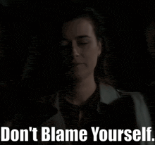 a woman with her eyes closed and the words " do n't blame yourself " above her