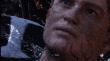 a close up of venom 's mouth with a man 's face in the foreground