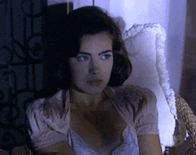 a woman is sitting in a chair and looking at the camera