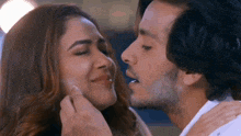 a man is kissing a woman on the forehead