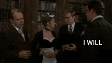 a man in a suit and tie is talking to a woman in a maid costume in a room .