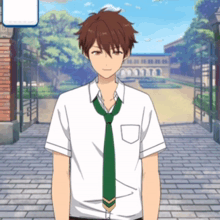 a man in a white shirt and green tie stands in front of a brick building