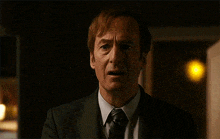a man in a suit and tie is making a funny face