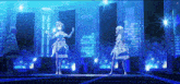 two anime girls are dancing on a stage in front of a city skyline at night