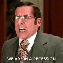 a man in a suit and tie is screaming and saying we are in a recession