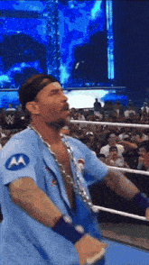 a wrestler wearing a blue shirt with a motorola logo on it