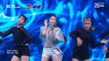 a group of women are dancing on a stage with the words we are k pop on the bottom right