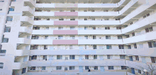 a large white building with a pink stripe on the side