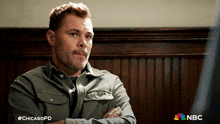 a man with his arms crossed and #chicagopd written on the bottom of his shirt