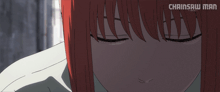 a close up of a girl 's face with the words chainsaw man on the bottom