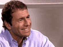 a close up of a man 's face with a smile on his face