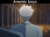a man walking down a street with the words anemic boys on the bottom