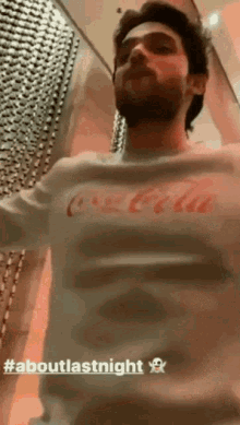 a man in a coca cola shirt is dancing