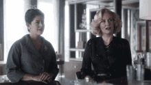 two women sitting next to each other in a room with the word cast on the bottom