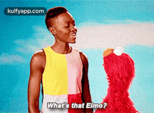 a man is standing next to a stuffed animal and talking to it .