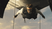 a man is flying through the air while wearing goggles and gloves
