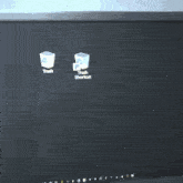 a computer monitor has a black screen and a few white icons on it