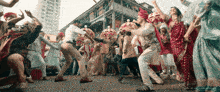 a group of people are dancing in front of a building that says ' a ' on it