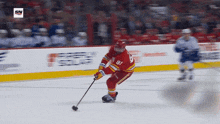 a hockey player with the number 87 on his jersey is holding a puck