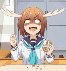 a girl with antlers on her head is holding a donut