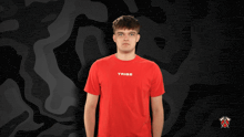 a man wearing a red shirt that says tribe
