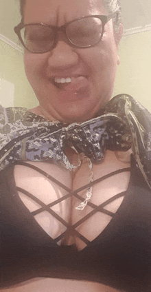 a woman wearing glasses is sticking her tongue out