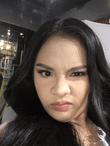 a close up of a woman 's face with a serious look on her face