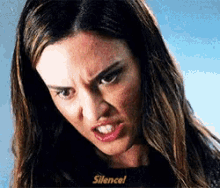 a close up of a woman 's face with the words silence written on the bottom