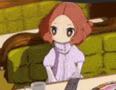 a little girl is sitting at a table with a cup of coffee .