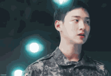 a close up of a man in a military uniform with the letters army on it