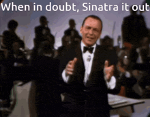 a man in a tuxedo singing into a microphone with the words when in doubt sinatra it out