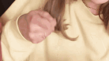a close up of a person 's hands holding something in their hand .