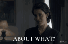 a woman in a suit and pearls is asking about what on netflix