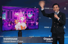 a man in a suit stands in front of a tv screen that says ironmouse demon queen vtuber on the bottom