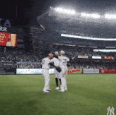 new york yankees baseball players on the field hugging