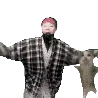 a man in a plaid shirt is standing next to a cat with a pink headband