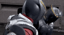 a man in a knight 's armor is fighting another man in a black armor .