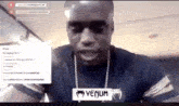 a man wearing a black shirt with venum written on the front