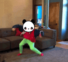 a child is dancing in a living room with a panda on his head