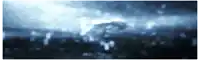 a blurred image of a dark sky with a few clouds