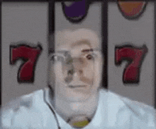 a man with glasses is playing a slot machine and winning a jackpot .