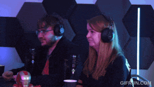 a man and a woman wearing headphones with the website gifrun.com in the lower right corner