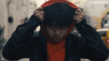 a man wearing a red hoodie has the hashtag #karatekidmovie on the bottom