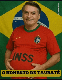 a man in a red inss shirt holds his belly