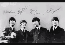 a black and white photo of the beatles with their autographs