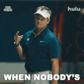a man in a blue shirt and white hat says " when nobody 's " in white letters