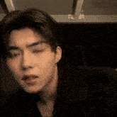 a close up of a man 's face in a dark room .
