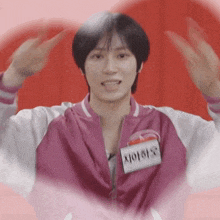 a man in a pink jacket with a name tag that says ' aoi '
